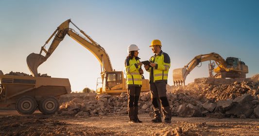 2 workers at a mine site planning their presplit blasting technique