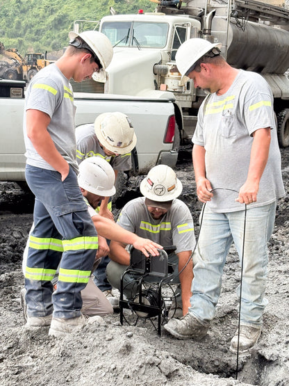 group of blasters working with the MTi Group borehole camera to inspect a hole. 